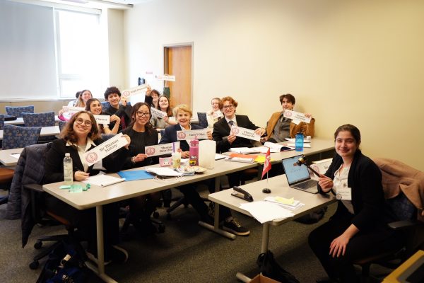 Students sitting at a table and participating in a global simulation